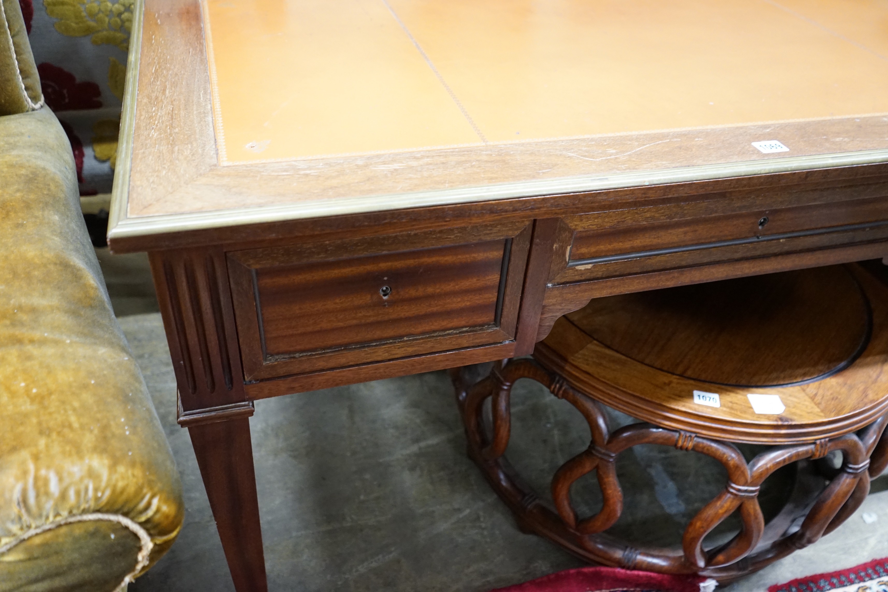 An Empire style brass mounted mahogany kneehole desk, width 130cm, depth 66cm, height 76cm